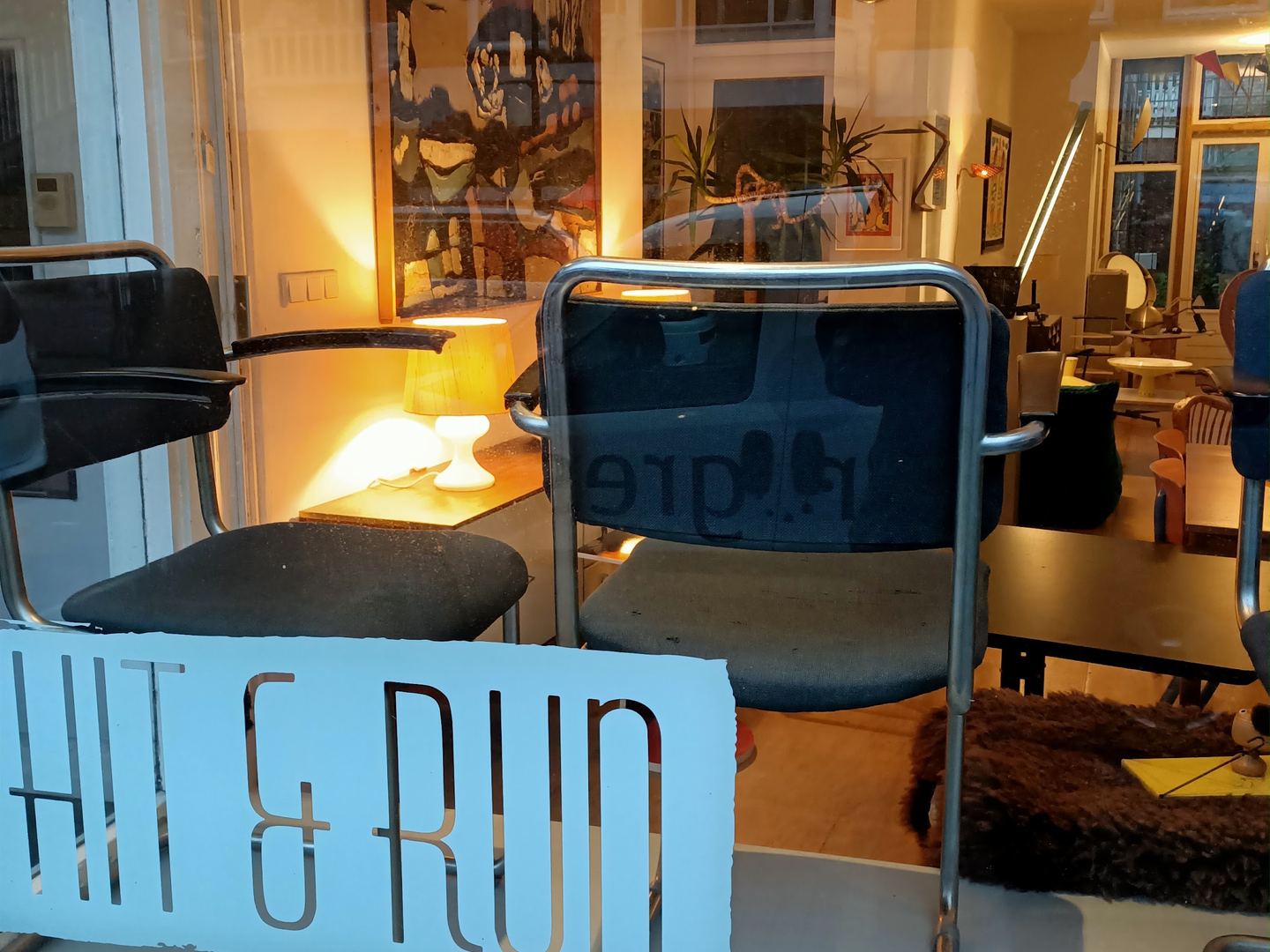 Etalage van Hit & Run Vintage Store met naambord en vintage stoelen