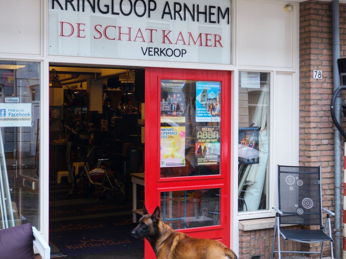 Winkelpui van Kringloop Arnhem De Schatkamer met naambord en rode deur