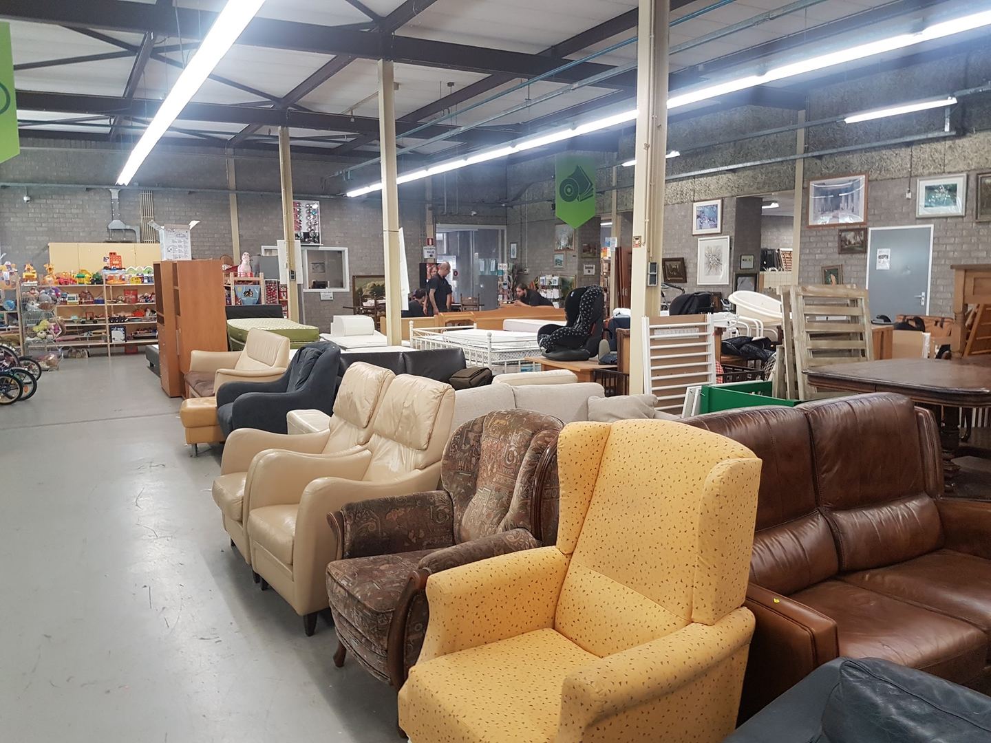 Meubelafdeling van Kringloopwinkel Helmond met rijen banken en fauteuils