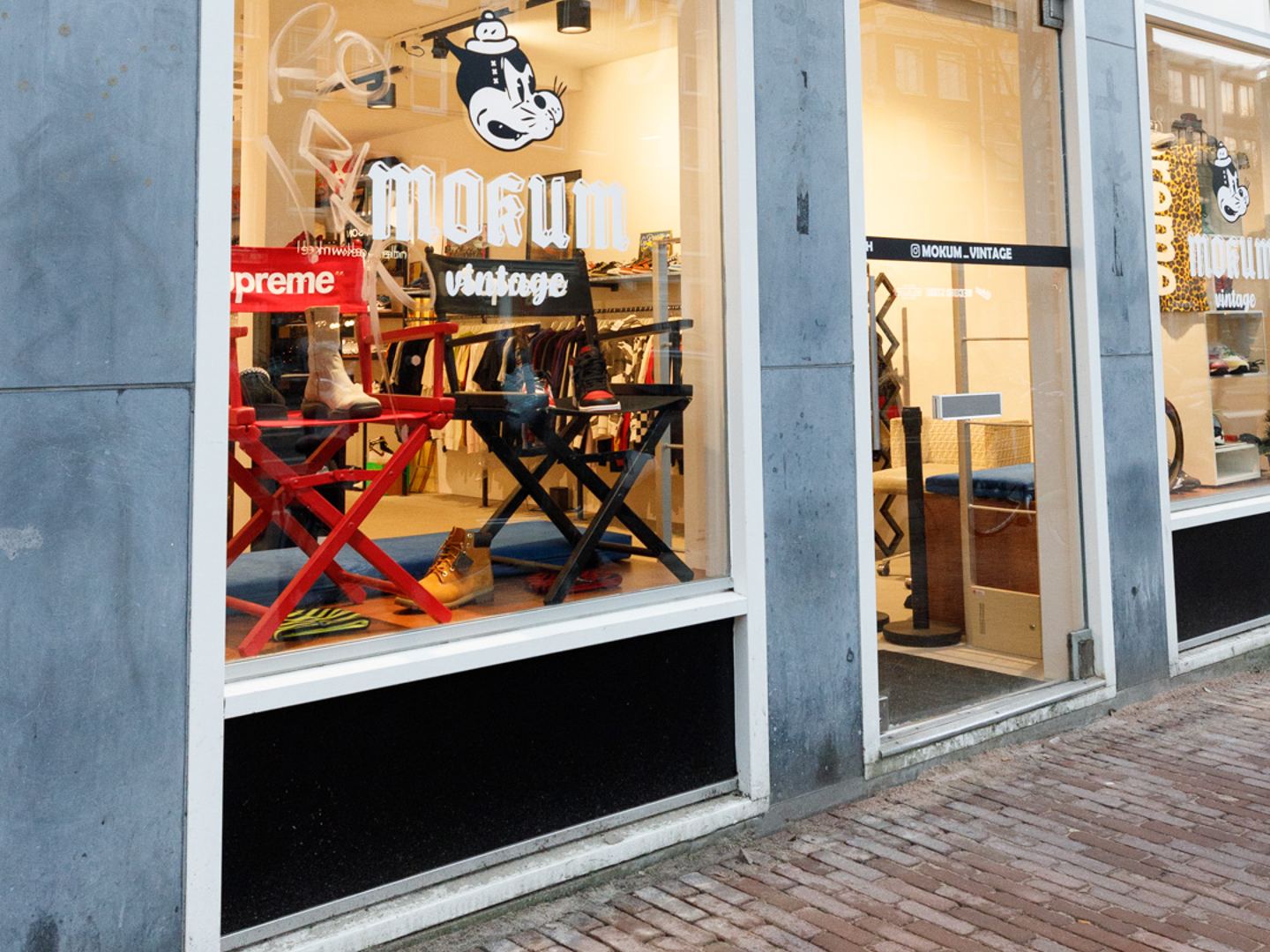 Gevel van Mokum Vintage met etalage, uithangbord en logo op het raam