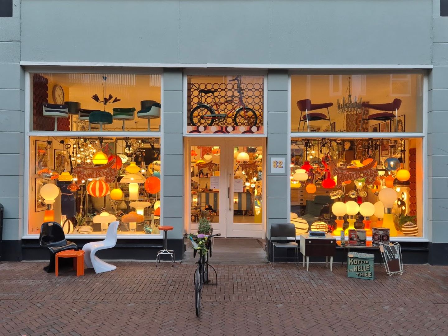 Etalages van Mr. Frintage vol oranje en witte vintage lampen en designstoelen