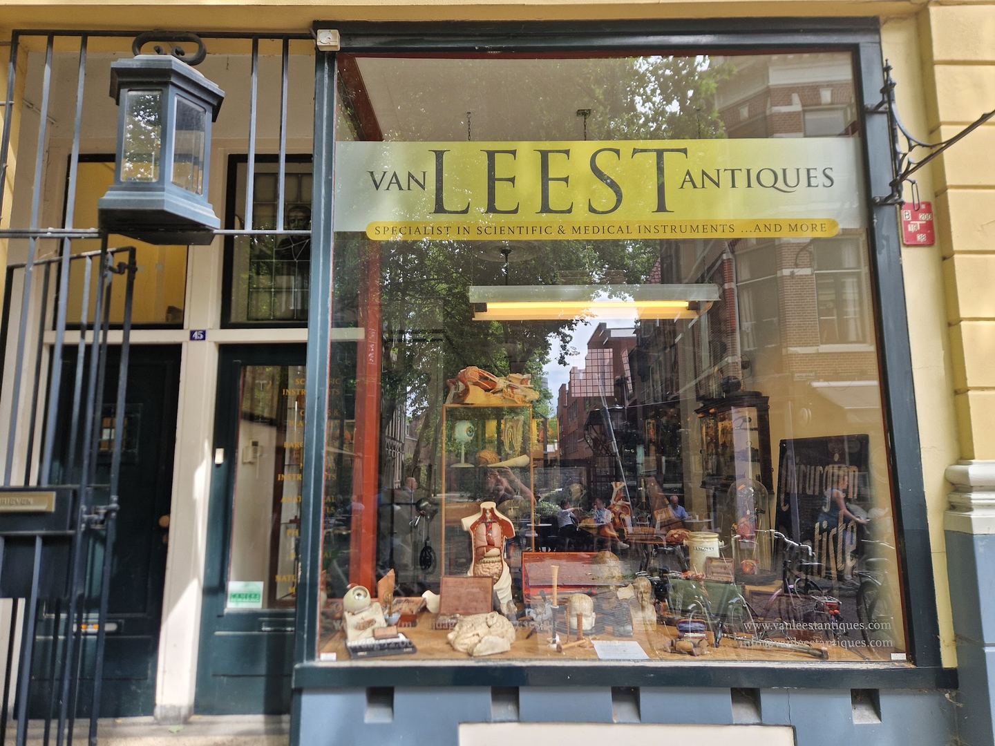 Etalage van Van Leest Antiques met anatomische modellen, globes en wetenschappelijke instrumenten