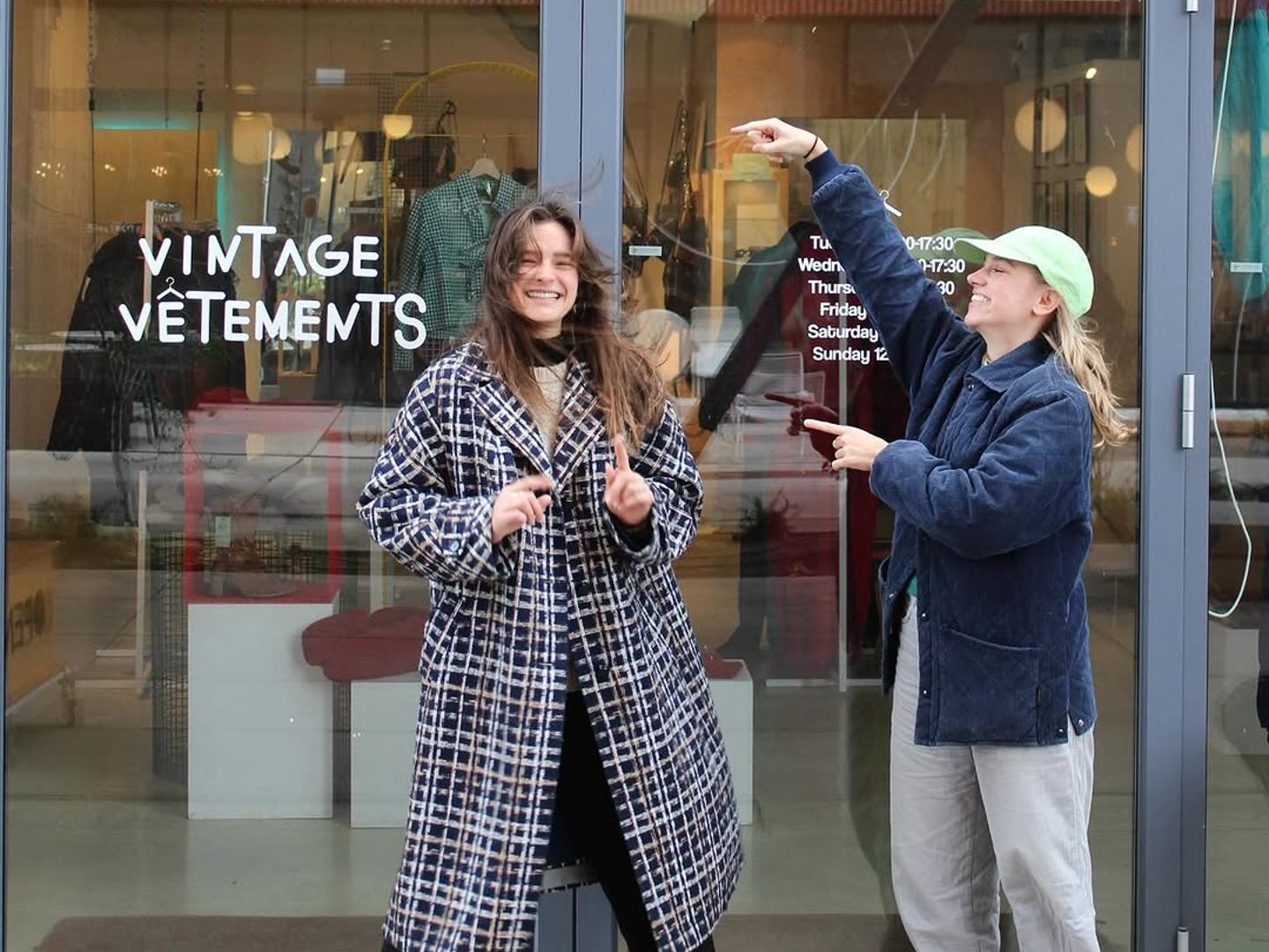A storefront for Vintage Vêtements with the name written on the glass door.